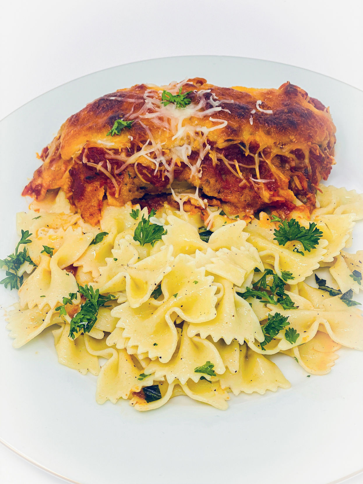 Cheesy Chicken Parmesan with Bow Tie Noodles and Marinara Sauce